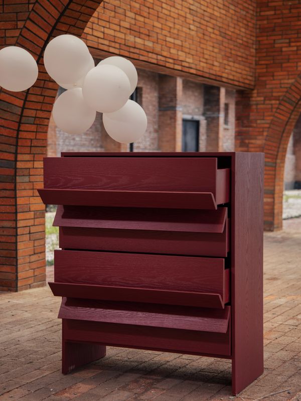 Tilt Chest with angled drawer fronts photographed under brick arches